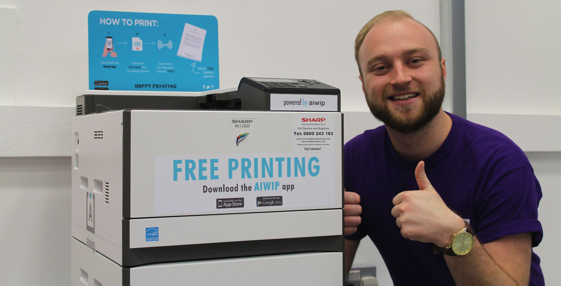 A student next to a prototype print station